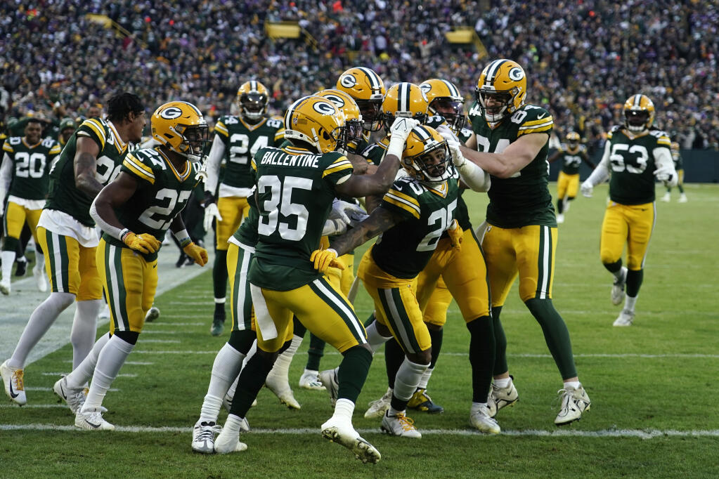 Green Bay Packers cornerback Keisean Nixon (25) celebrates with teammates after returning a kickoff for a touchdown during the first half of an NFL football game against the Minnesota Vikings, Sunday, Jan. 1, 2023, in Green Bay, Wis. (AP Photo/Morry Gash)