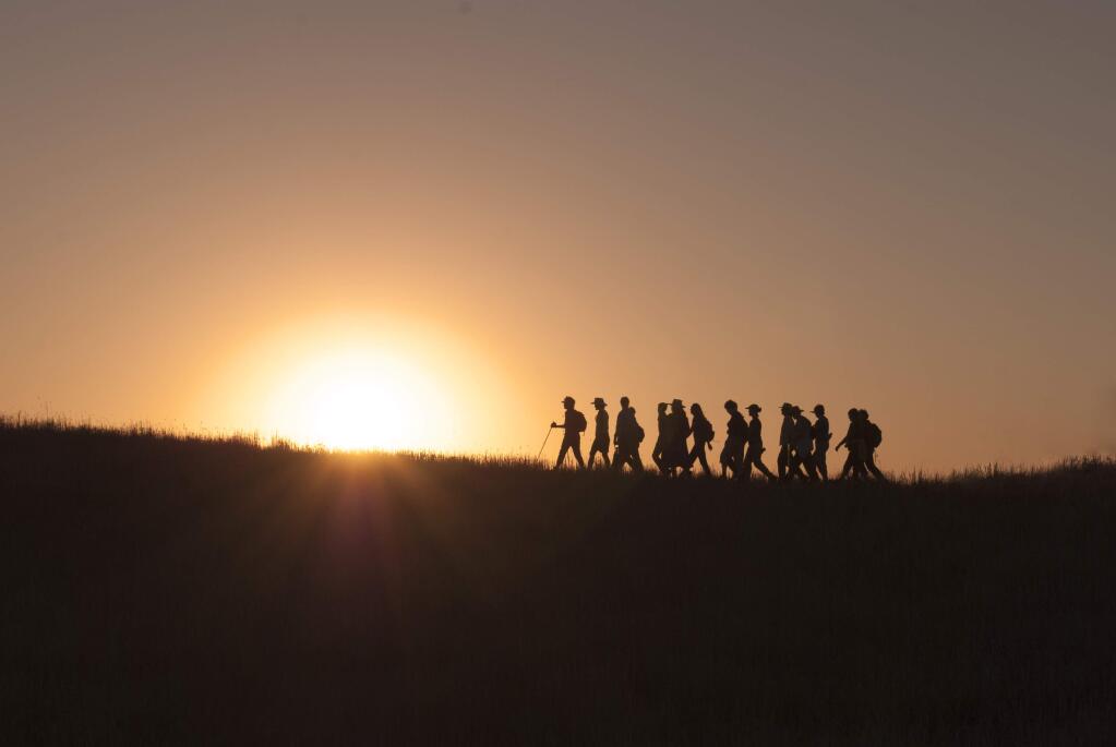 Pepperwood Preserve members hike a ridge at sunset. (Tom Greco)