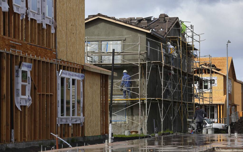 Construction workers building a home in the University District development in Rohnert Park in February 2018. (CHRISTOPHER CHUNG / The Press Democrat)