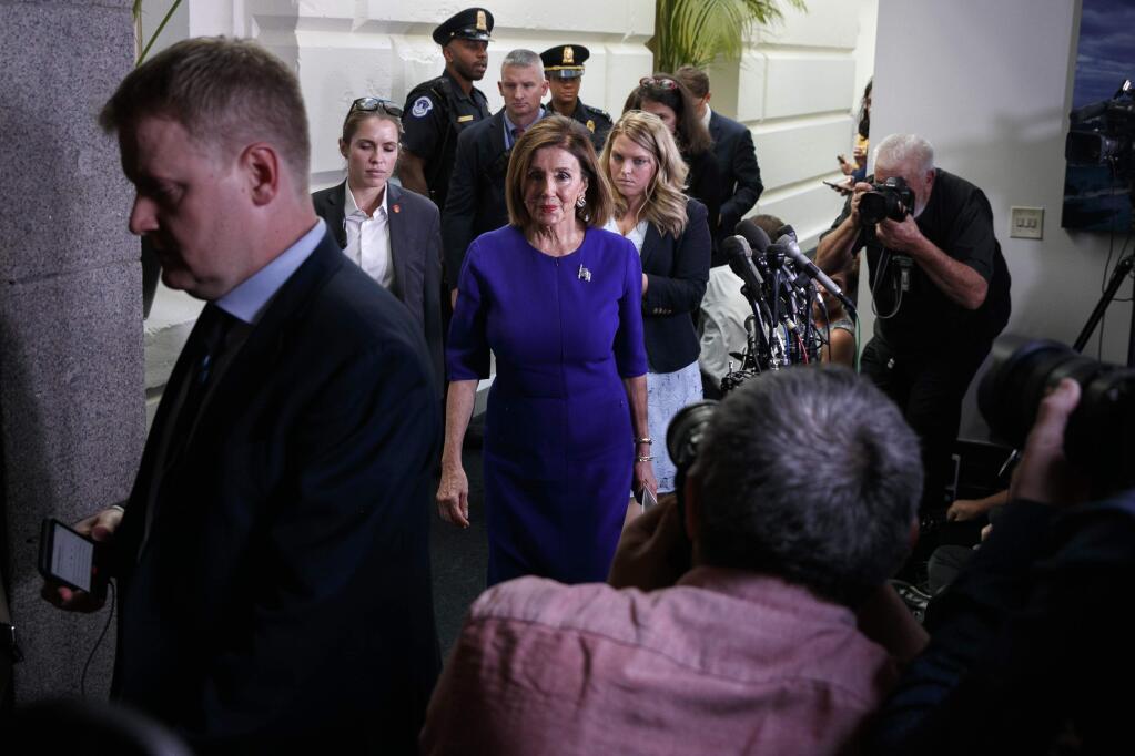 House Speaker Nancy Pelosi of Calif., center, walks past the media after attending a closed door caucus meeting about impeachment, Tuesday Sept. 24, 2019, on Capitol Hill in Washington. (AP Photo/Jacquelyn Martin)