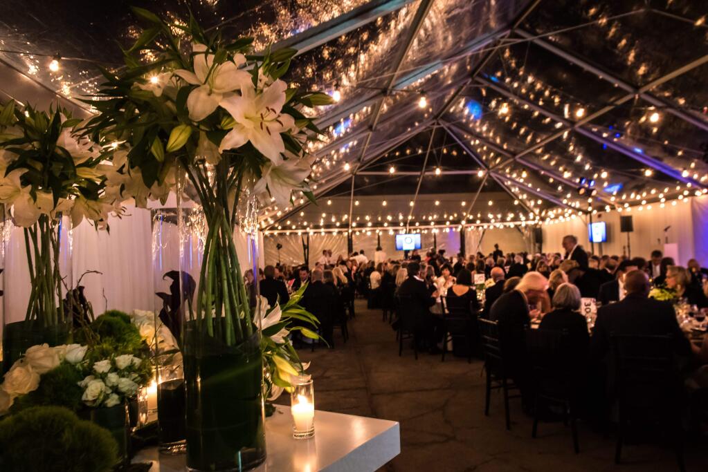 Photo credit: Grace Cheung-Schulman, The moon lit marquee decorated with flowers and lights, filled with 260 guests celebrating 20 years of the Sonoma Valley Museum of Art .