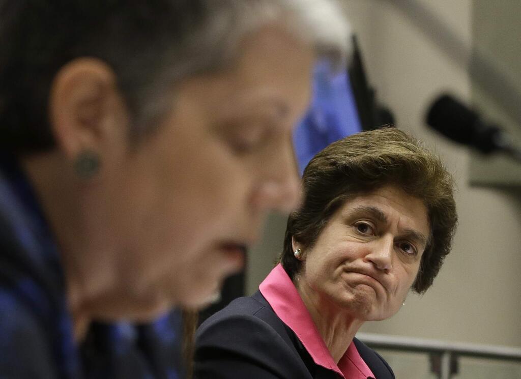 File - In this May 2, 2017, file photo, State Auditor Elaine Howle, right, looks over as University of California President Janet Napolitano reads her statement concerning the audit conducted by Howle's office, during a hearing of the Joint Legislative Audit Committee in Sacramento, Calif. Top advisers Napolitano improperly interfered in a state audit to tone down critical comments from campus administrators about the president's office, an investigation ordered by the UC regents found. The investigation finds that officials in the president's office instructed UC campuses not to 'air dirty laundry' to the state auditor, according to the San Francisco Chronicle, Wednesday, Nov. 15, 2017,, which reviewed the report ahead of its public release on Thursday. (AP Photo/Rich Pedroncelli, File)