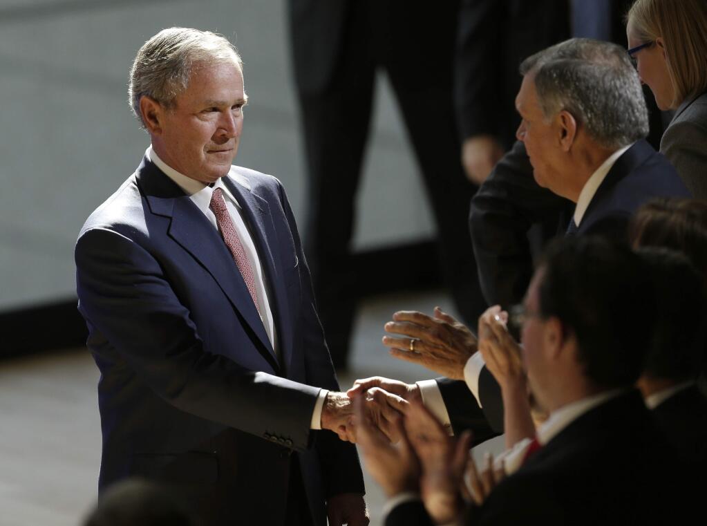 Former U.S. President George W. Bush shakes hands with audience members after speaking at a forum sponsored by the George W. Bush Institute in New York, Thursday, Oct. 19, 2017. (AP Photo/Seth Wenig)