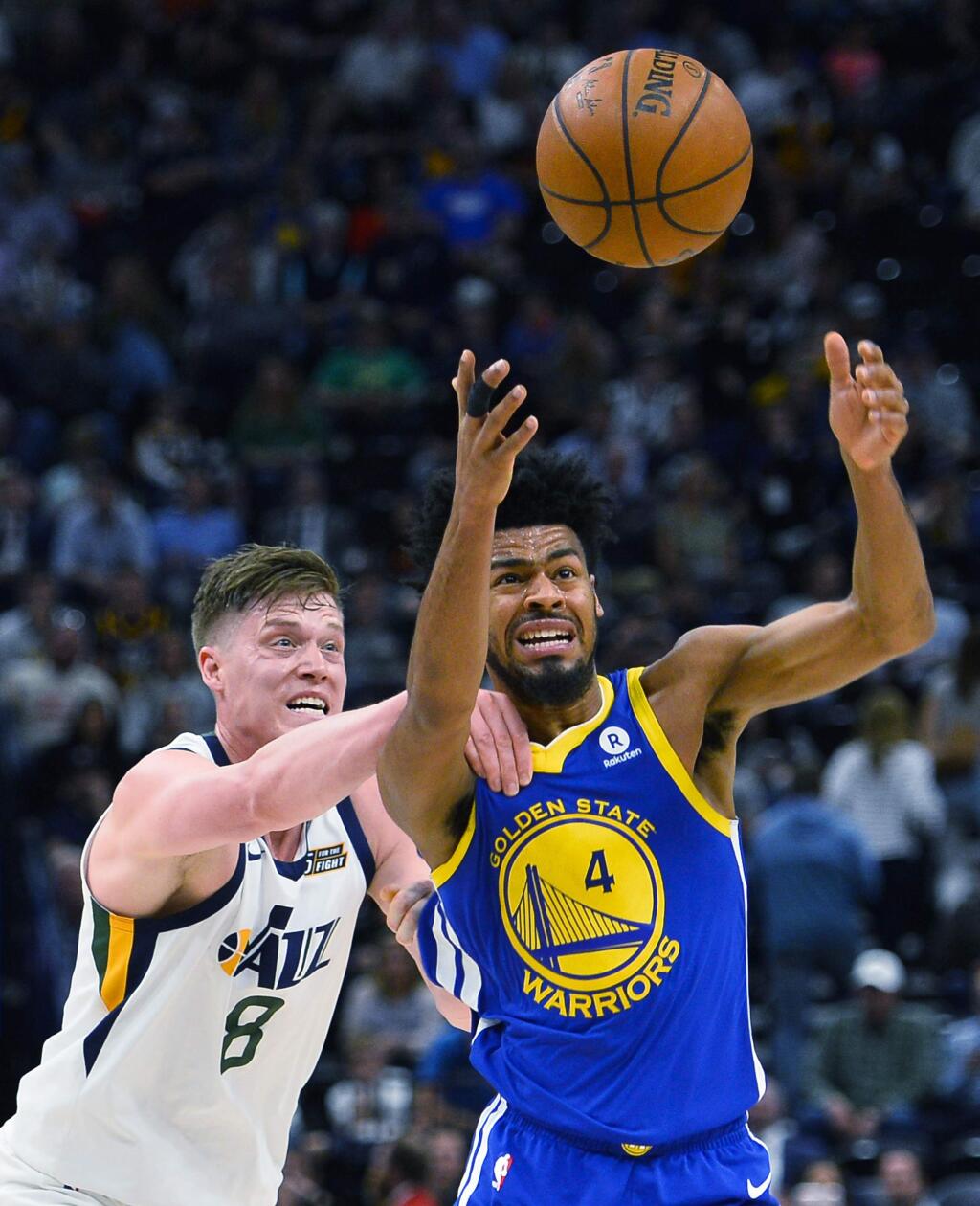 Utah Jazz forward Jonas Jerebko (8) fights for the ball with Golden State Warriors guard Quinn Cook (4) in the second half of an NBA basketball game Tuesday, April. 10, 2018, in Salt Lake City. (AP Photo/Alex Goodlett)