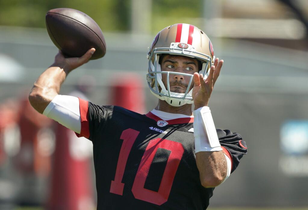FILE - In this Tuesday, June 10, 2019 file photo, San Francisco 49ers quarterback Jimmy Garoppolo throws a pass during a drill at the team's NFL football training facility in Santa Clara, Calif. Jimmy Garoppolo had a practice to forget in his final session before facing an opposing defense for the first time since suffering a season-ending knee injury last September. Garoppolo threw interceptions on five straight pass attempts at practice for the San Francisco 49ers on Wednesday, Aug. 14, 2019 in by far his worst session in his return from the torn ACL that cut short his 2018 season after three games.(AP Photo/Tony Avelar, File)