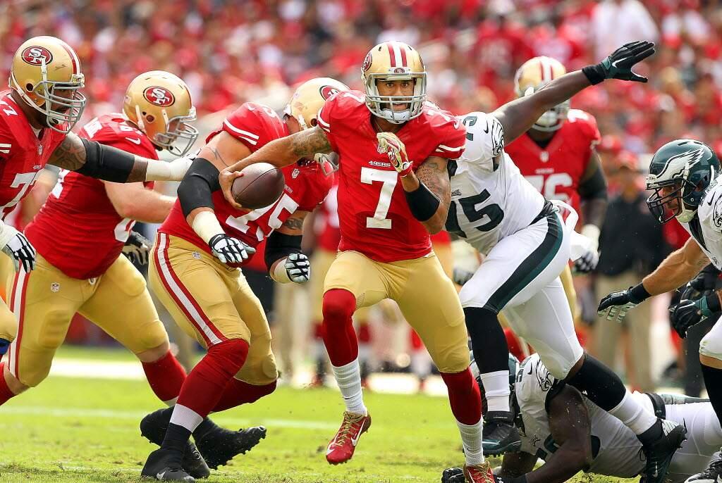 Colin Kaepernick scrambles for a first down in the fourth quarter of the game against the Eagles on Sept. 28, (John Burgess / The Press Democrat)