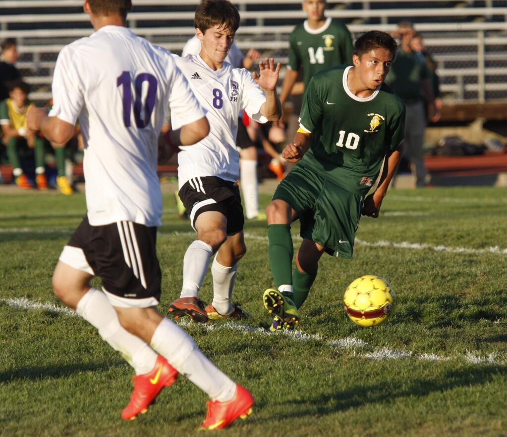 Casa Grande's Grauier Pacheco controls the ball in front of Petaluma's Kevin Rojas in the second half of their game at PHS in Petaluma on Tuesday August 26, 2014. Both Pacheco and Rojas scored in game. (SCOTT MANCHESTER/ARGUS-COURIER STAFF)