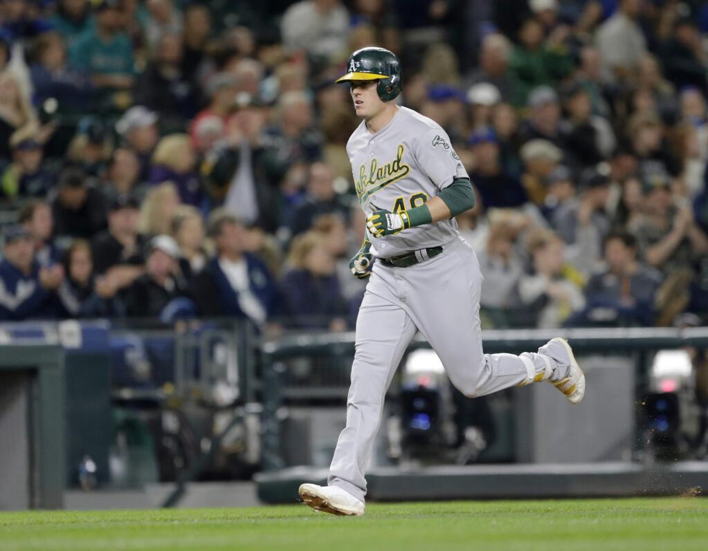 Oakland Athletics' Ryon Healy rounds the bases after hitting a solo home run off Seattle Mariners starting pitcher Taijuan Walker during the sixth inning of a baseball game Friday, Sept. 30, 2016, in Seattle. (AP Photo/John Froschauer)