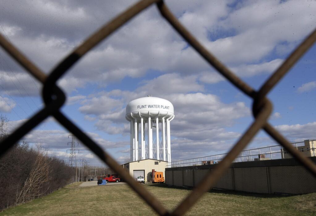 FILE - In this March 21, 2016 file photo, the Flint Water Plant water tower in Flint, Mich. The House has approved a wide-ranging bill to approve water projects across the country, including $170 million to address lead in Flint, Michigan's drinking water and $558 million to provide relief to drought-stricken California. (AP Photo/Carlos Osorio File)