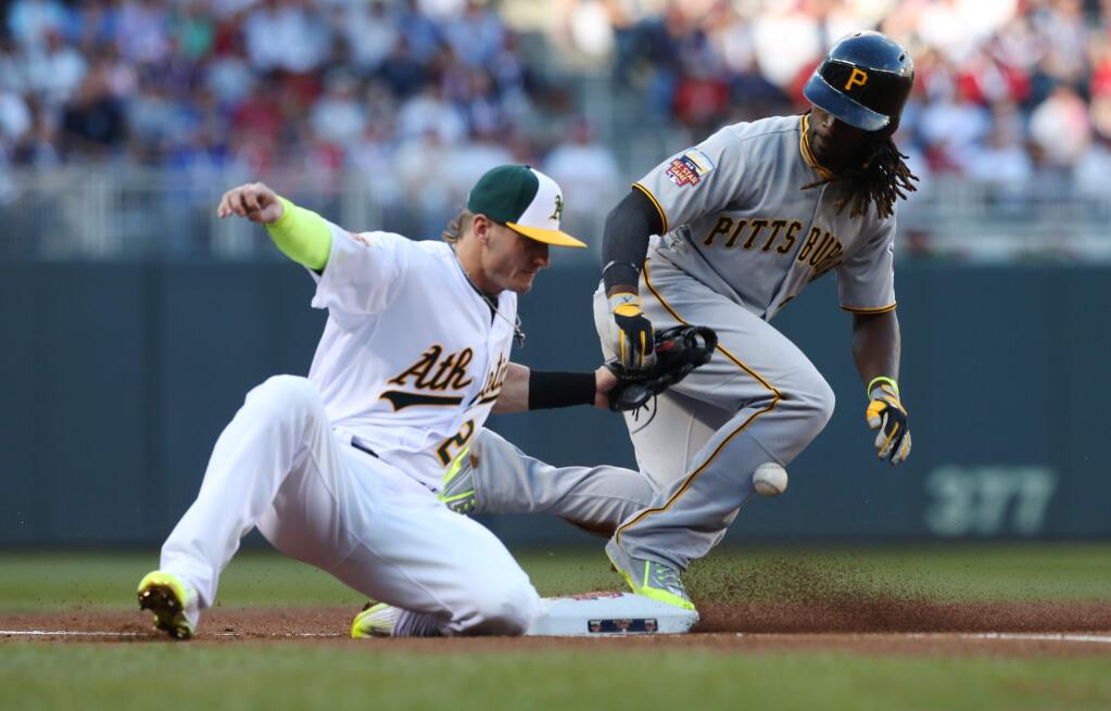 National League outfielder Andrew McCutchen, of the Pittsburgh Pirates, steals third base as American League Josh Donaldson, of the Oakland Athletics, tries to make the tag during the first inning of the MLB All-Star baseball game, Tuesday, July 15, 2014, in Minneapolis. (AP Photo/Jim Mone)