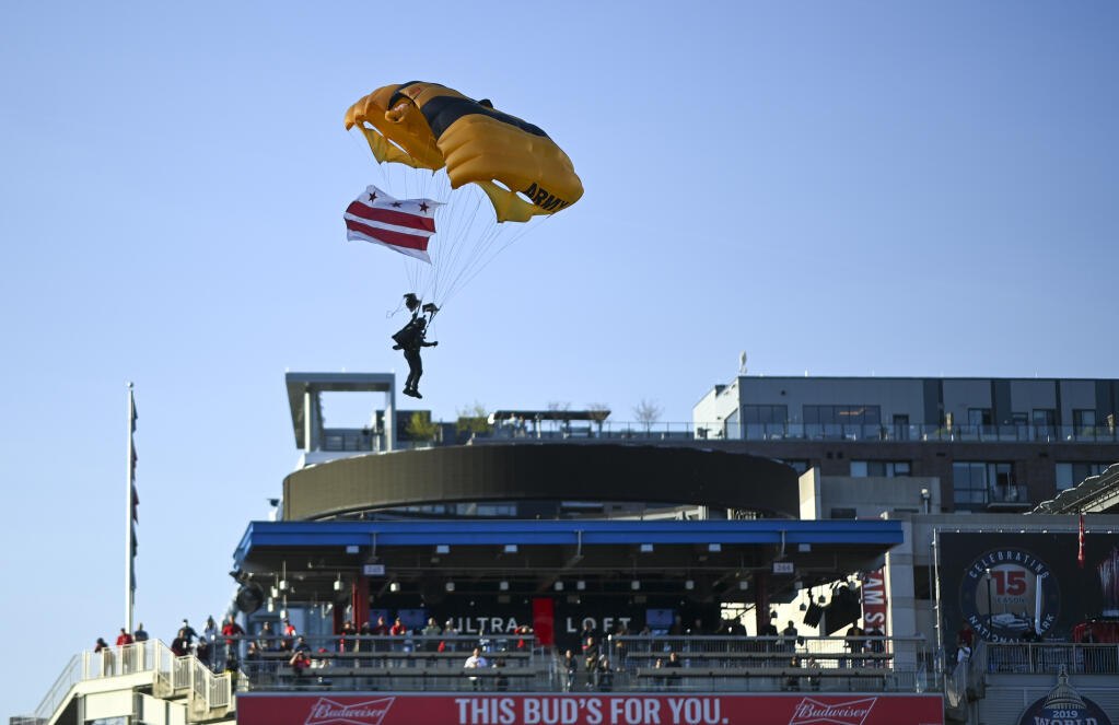 The Golden Knights, a U.S. Army team, parachute into Nationals Park on Wednesday night — a coordinated stunt that triggered an evacuation of the Capitol. (Washington Post photo by Jonathan Newton)