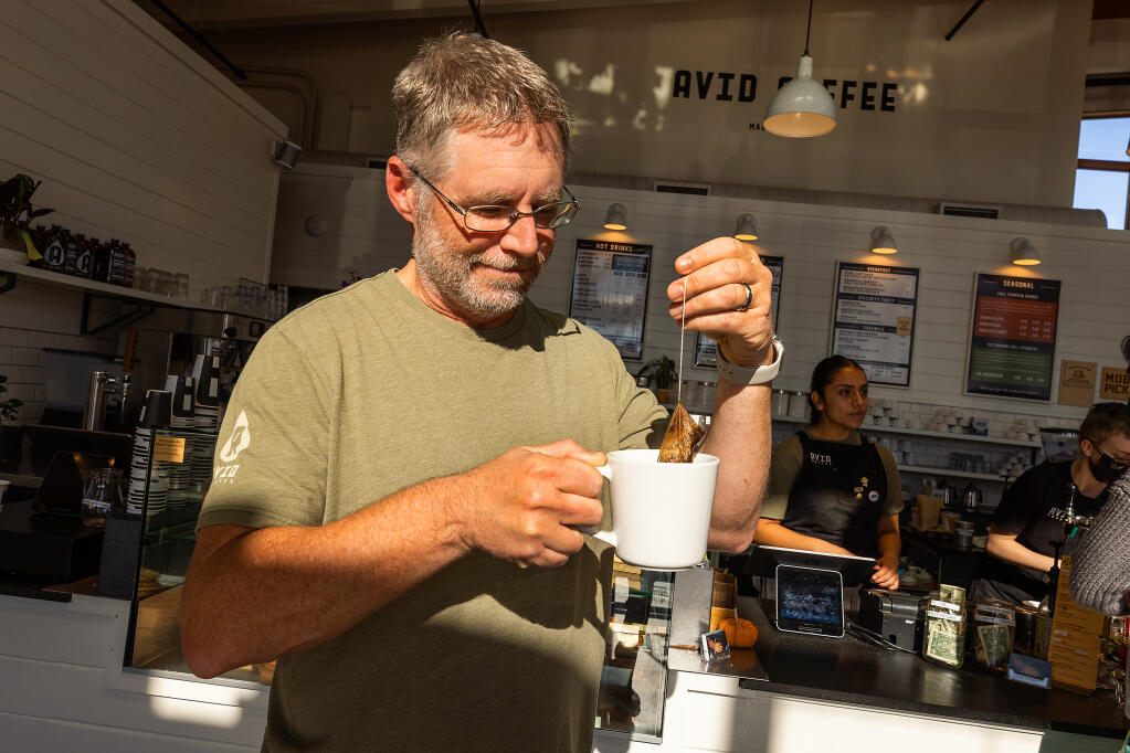 Rob Daly, owner of Avid Coffee, with his new instant bag coffee, a few minutes of steeping are required, at the Montgomery Village store in Santa Rosa Tuesday Nov. 15, 2022. (John Burgess/Press Democrat)