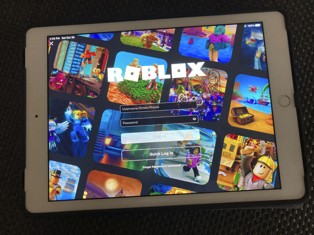 The gaming platform Roblox is displayed on a tablet, Saturday, Oct. 30, 2021 in New York.  To the dismay of millions of children -- and the parents trying to keep them busy and cope with their anguish --  the popular gaming platform  crashed Friday, Oct. 29, and the company was still trying to restore service Saturday.  (AP Photo/Leon Keith)