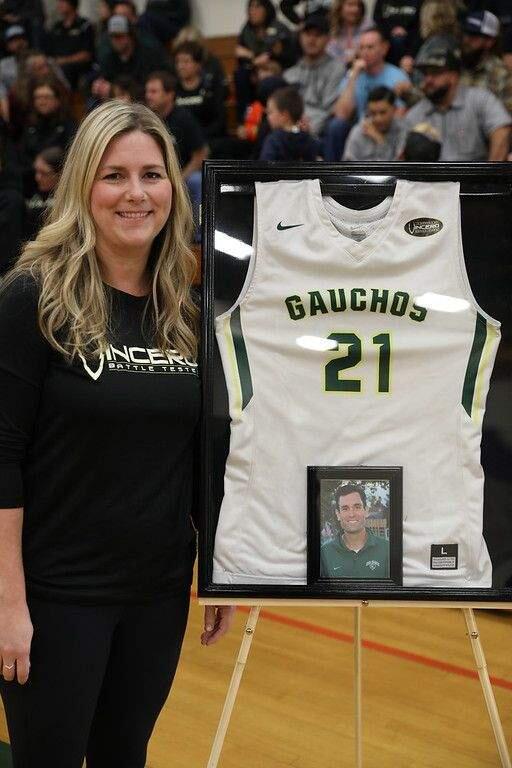 PHOTO BY CAMPBELLSPORTSPHOTOJames Forni's wife, Mary, with her late husband's framed jersey that will be on display at Casa Grande High School following the retirement of his Gaucho number.