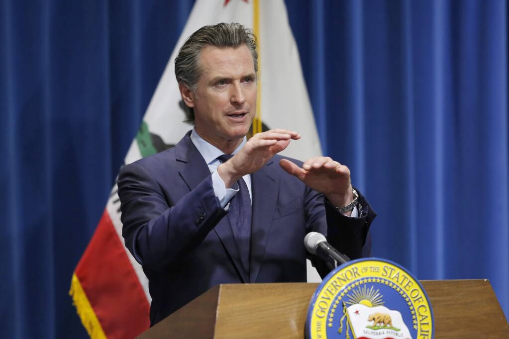 FILE - In this May 14, 2020, file photo, California Gov. Gavin Newsom discusses his revised 2020-2021 state budget during a news conference in Sacramento, Calif. The California Senate's plan to cover a projected budget deficit rejects Gov. Gavin Newsom's proposed cuts to public education and health care programs. Newsom's plan would cut funding for public schools by about $8 billion. The Senate's plan would restore $2.7 billion of those cuts, the rest being deferred to future years. (AP Photo/Rich Pedroncelli, Pool, File)
