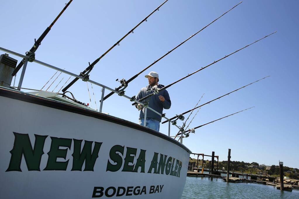 Deckhand Dana Amundsen prepares the New Sea Angler for the salmon fishing season in Bodega Bay on Wednesday, April 2, 2014.. (Conner Jay/The Press Democrat)
