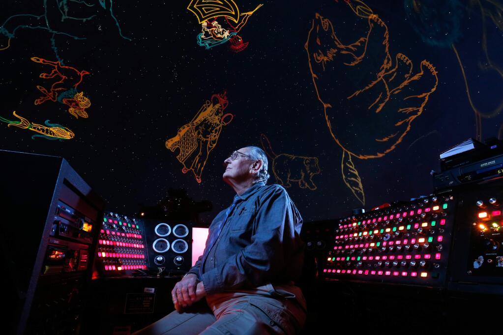 Stars and constellation shapes are projected on the planetarium dome as planetarium director Ed Megill, 75, sits at the control station in Lark Hall at Santa Rosa Junior College in Santa Rosa, California on Friday, March 11, 2016. (Alvin Jornada / The Press Democrat)