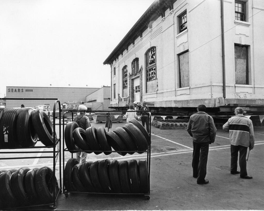In the seventies, the Santa Rosa Urban Renewal Agency had plans to build a regional shopping center (Santa Rosa Plaza) on the site on the 5th and A street location. To persevere the historic structure plans were made to relocate the entire building. In this photo Sears looms in the background of the lifted former post office. (Joe Price Jr. / The Press Democrat, 1979)