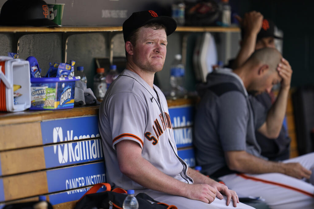 Giants pitcher Logan Webb sits in the dugout after being pulled against the Tigers in the fifth inning Wednesday in Detroit. (Paul Sancya / ASSOCIATED PRESS)