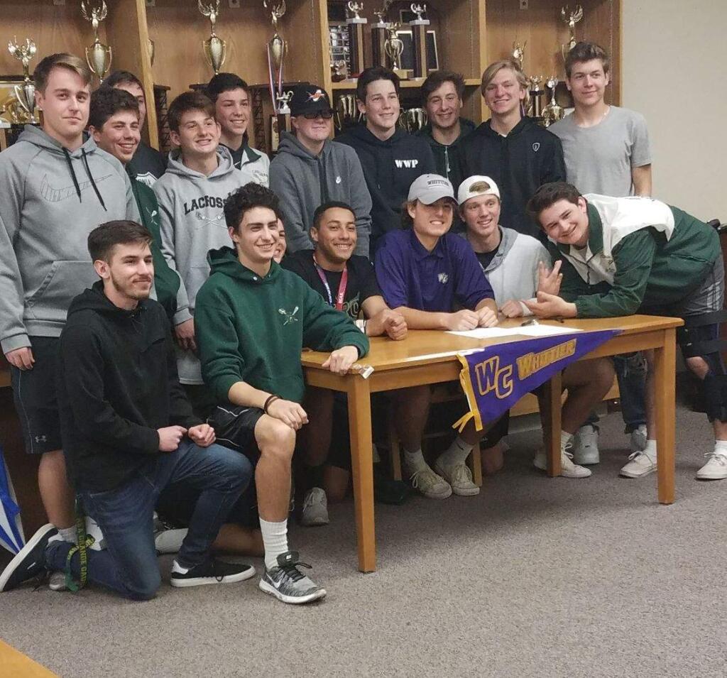 JOHN JACKSON/ARGUS-COURIER STAFFCasa Grande's Dylan Guth (center) surrounded by his Gaucho teammates signs a Letter of Intent to play lacrosse at Whittier College in Southern California.