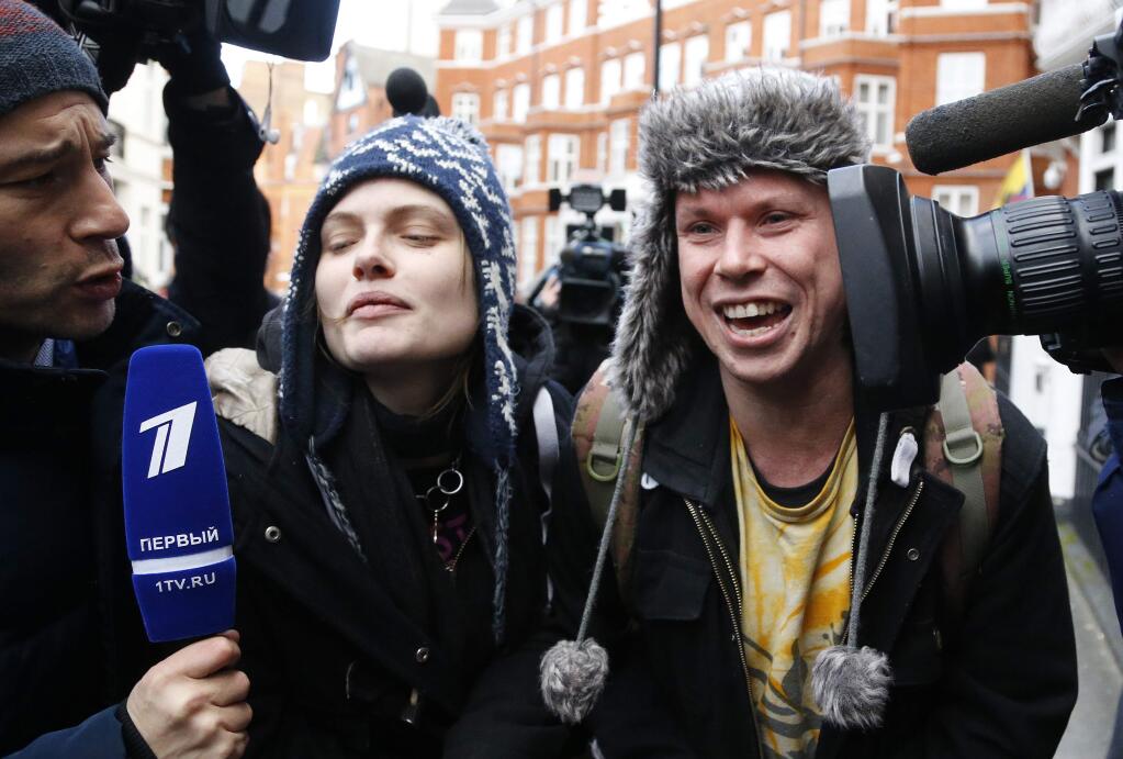 Lauri Love an alleged computer hacker who yesterday won his appeal to block his extradition to the United States, leaves the Ecuadorian embassy with girlfriend Sylvia Mann, left, after visiting Assange in London, Tuesday, Feb. 6, 2018. Lawyers for Julian Assange are asking a British court to drop an arrest warrant for the WikiLeaks founder. (AP Photo/Frank Augstein)