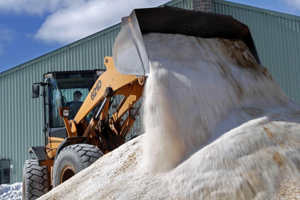 David Osgood, crew leader of the public works dept., mixes road salt, Monday, March 12, 2018, in Freeport, Maine. Much of the Northeast is bracing for blizzard conditions, a foot or more of snow and high winds as the third major nor'easter in 10 days bears down on the region. (AP Photo/Robert F. Bukaty)