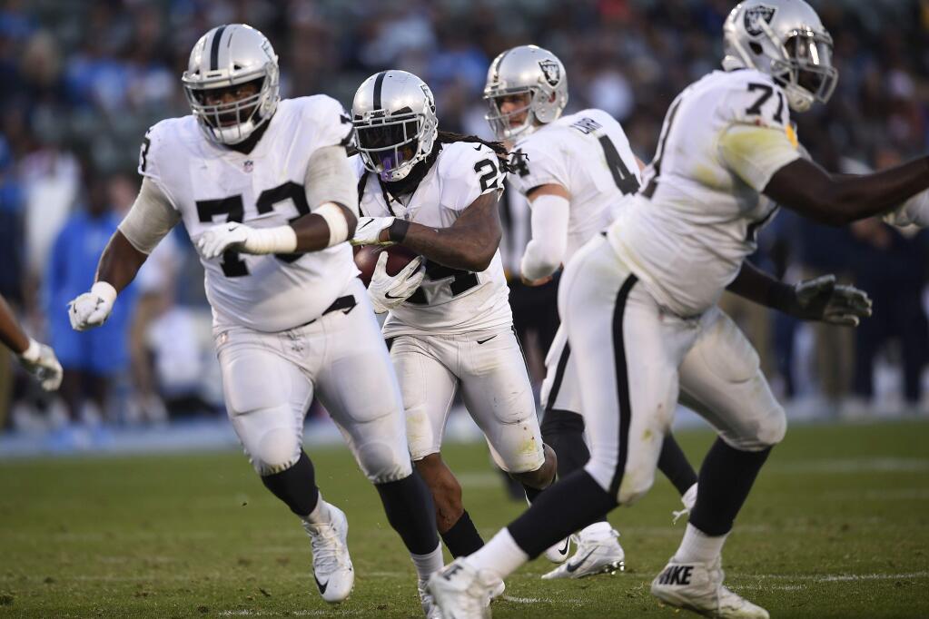 Oakland Raiders running back Marshawn Lynch runs upfield during the second half of an NFL football game against the Los Angeles Chargers, Sunday, Dec. 31, 2017, in Carson, Calif. Lynch passed 10,000 career rushing yards on the play, becoming the 31st player in NFL history to do so. (AP Photo/Kelvin Kuo)