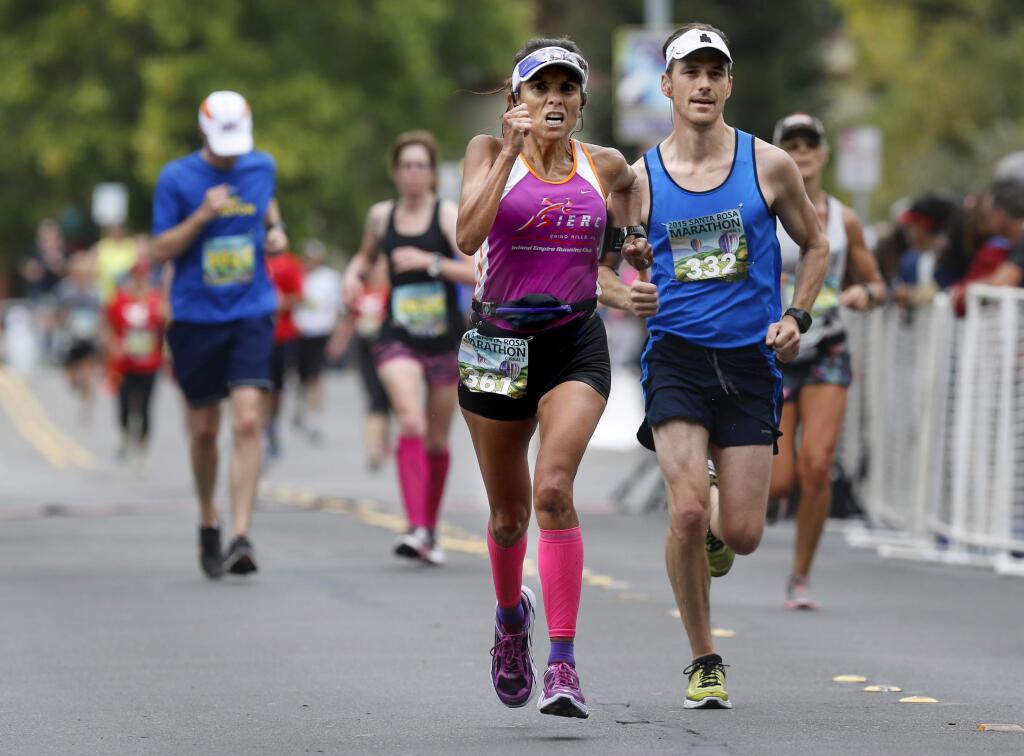 Dolores Valencia and Rusty Smith push toward the finish line during the Santa Rosa Marathon in Santa Rosa, on Sunday, Aug. 23, 2015. (BETH SCHLANKER/ PD)