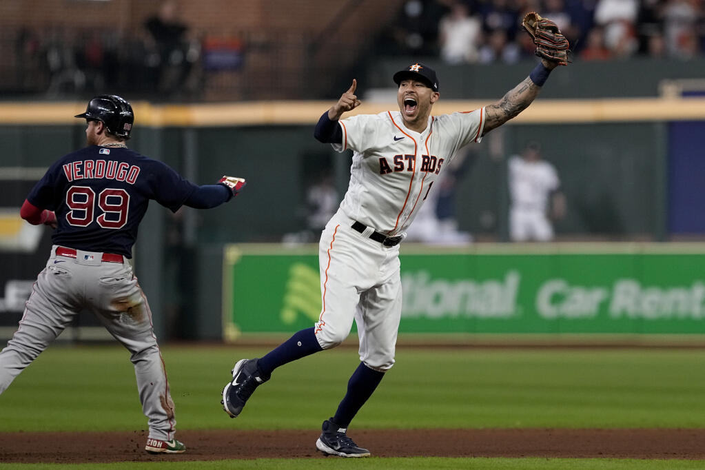 Houston Astros shortstop Carlos Correa celebrates after tagging out the Boston Red Sox’s Alex Verdugo at second to end the top of the seventh inning in Game 6 of the American League Championship Series on Friday, Oct. 22, 2021, in Houston. (Tony Gutierrez / ASSOCIATED PRESS)