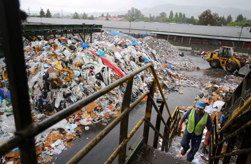 Raul Avalos walks up to the Redwood Empire Disposal's sorting line at the recycling center in Santa Rosa on Thursday, May 14, 2015. (CHRISTOPHER CHUNG/ PD)