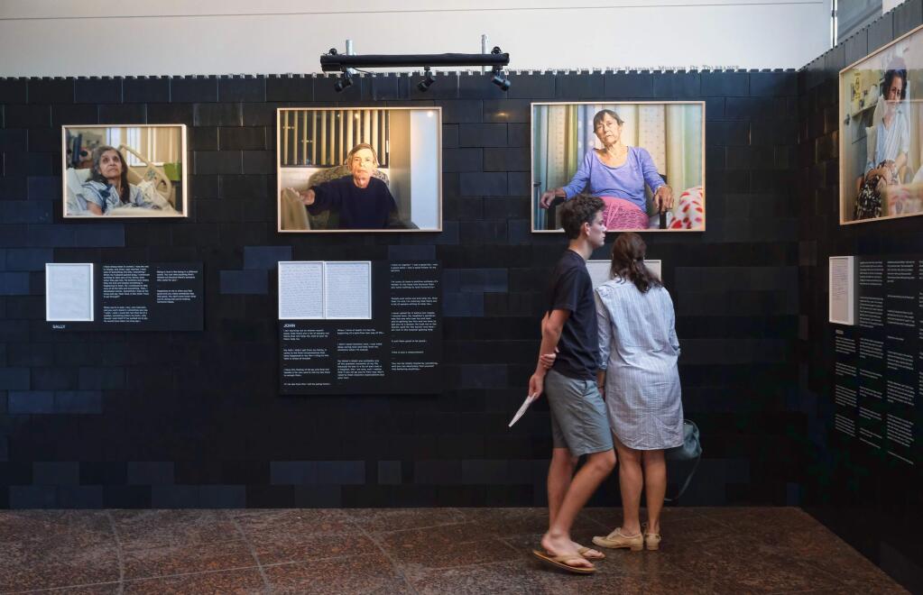 In this Aug. 15, 2016 photo, visitors tour a photography exhibit 'Right, Before I Die' by photographer Andrew George at the Museum of Tolerance in Los Angeles. (AP Photo/Richard Vogel)