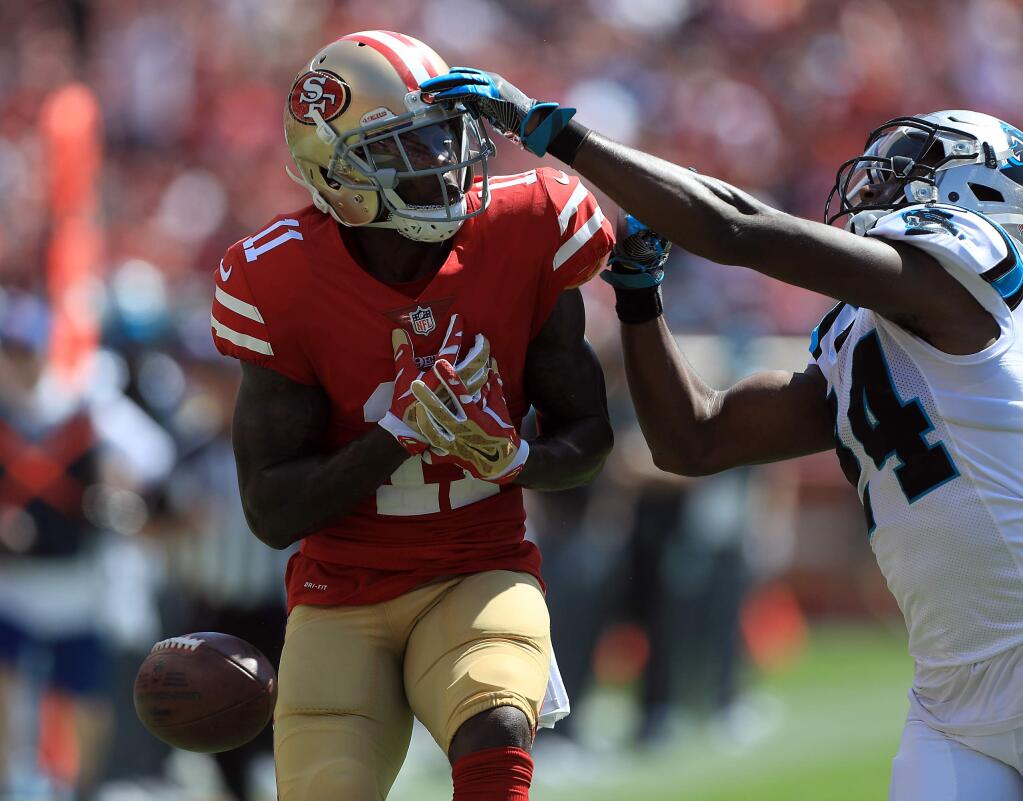 Marquise Goodwin of the 49ers has a long pass drop through his hands as Carolina's James Bradbury defends, in the first quarter, during San Francisco's 23-3 home opener loss at Levi's Stadium in Santa Clara, Sunday Sept. 10, 2017. (Kent Porter / The Press Democrat) 2017