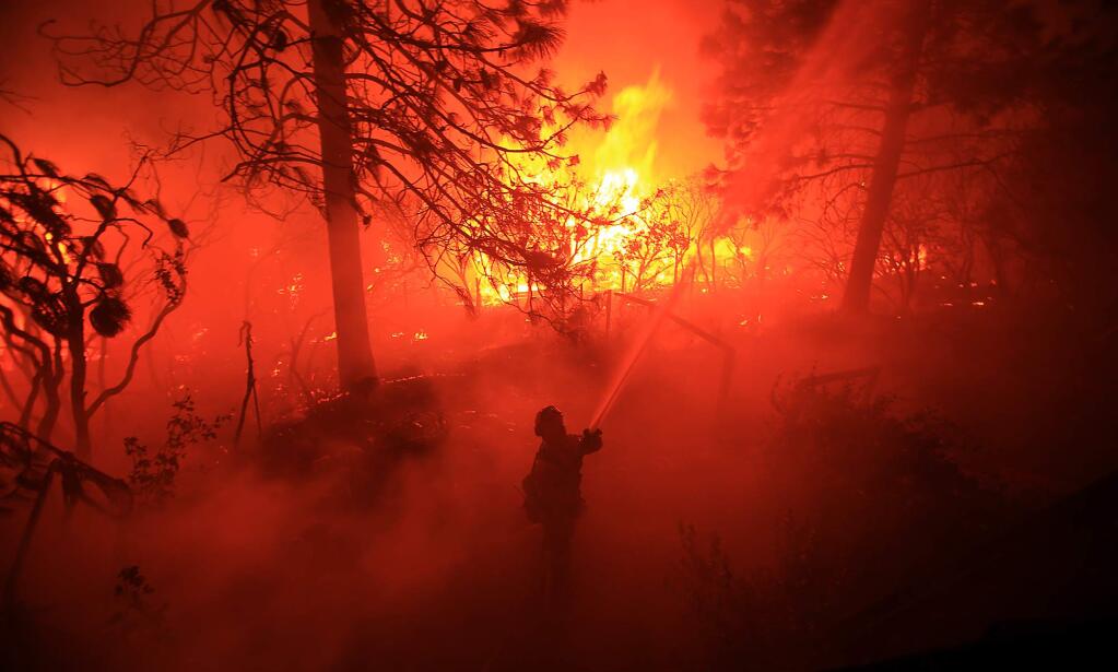 The Valley fire rages on Cobb Mountain in Lake County, Calif., as firefighters try to protect structures on Saturday, Sept 12, 2015. (Kent Porter / Press Democrat)