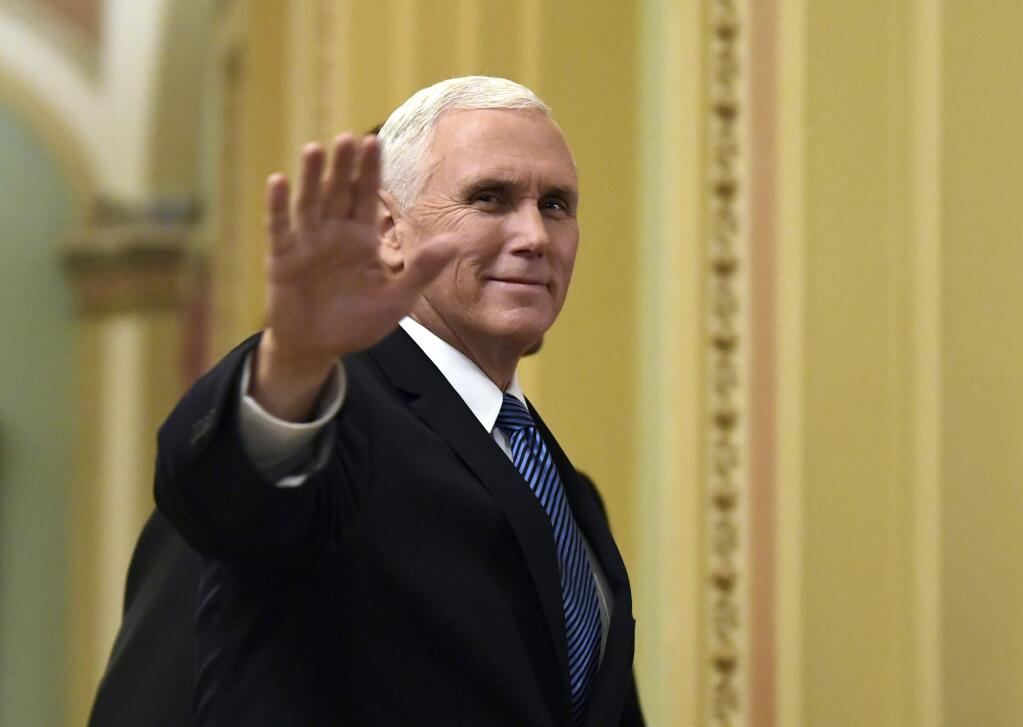 FILE - In this Jan. 3, 2018, file photo, Vice President Mike Pence waves as he walks on Capitol Hill in Washington. Pence is making his fifth visit to Israel, returning to a region he's visited “a million times' in his heart. An evangelical Christian with strong ties to the Holy Land, Pence this time comes packing two key policy decisions in his bags that have long been top priorities for him: designating Jerusalem as Israel's capital and curtailing aid for Palestinians.(AP Photo/Susan Walsh, File)