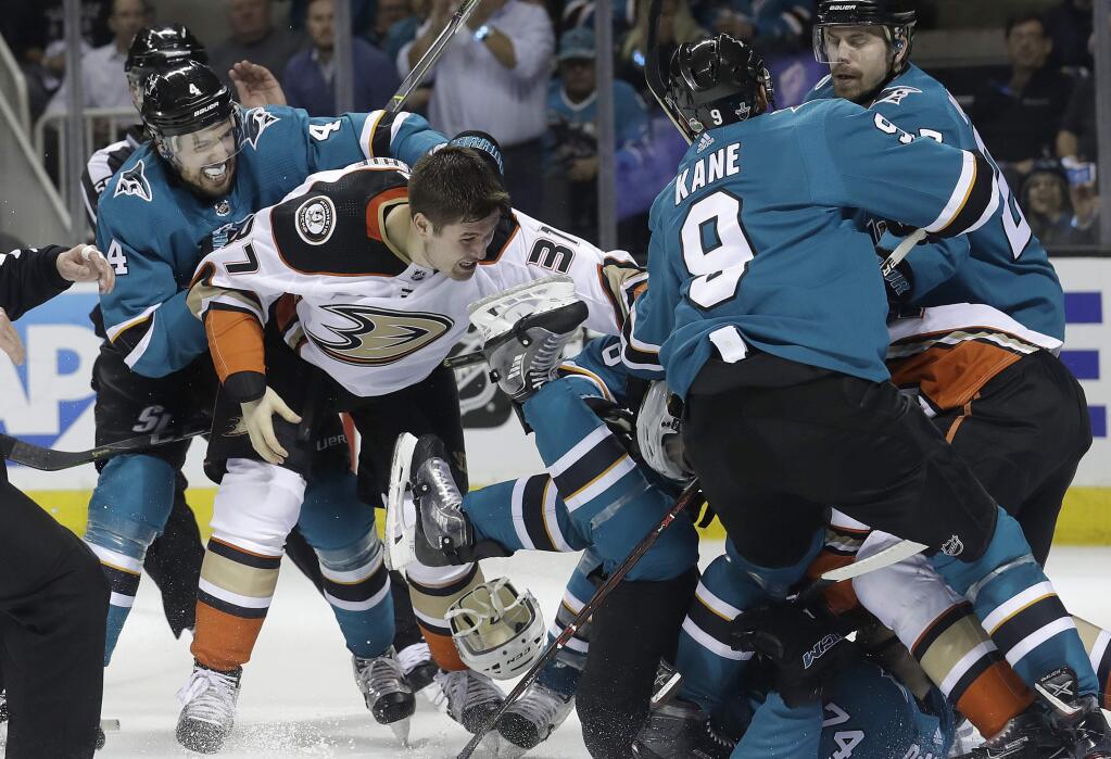 San Jose Sharks defenseman Dylan DeMelo, left, goes after Anaheim Ducks left wing Nick Ritchie (37) as players fight during the second period of Game 3 of an NHL hockey first-round playoff series in San Jose, Calif., Monday, April 16, 2018. (AP Photo/Jeff Chiu)