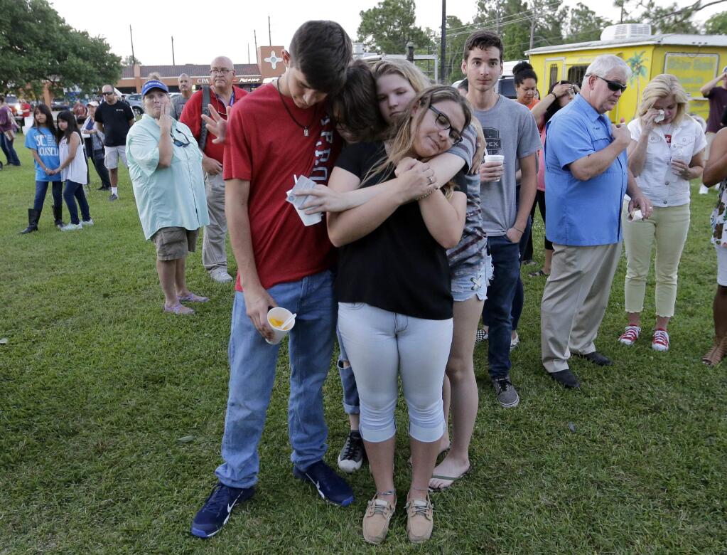 Mourners embrace each other during a prayer vigil following a shooting at Santa Fe High School in Santa Fe, Texas, on Friday, May 18, 2018. (AP Photo/David J. Phillip)