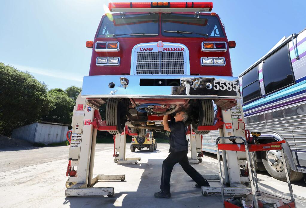 Jeff's Twin Oaks Garage owner Jeff LaGrave works on a Camp Meeker fire engine in Penngrove on Friday, April 24, 2020. (Christopher Chung/ The Press Democrat)