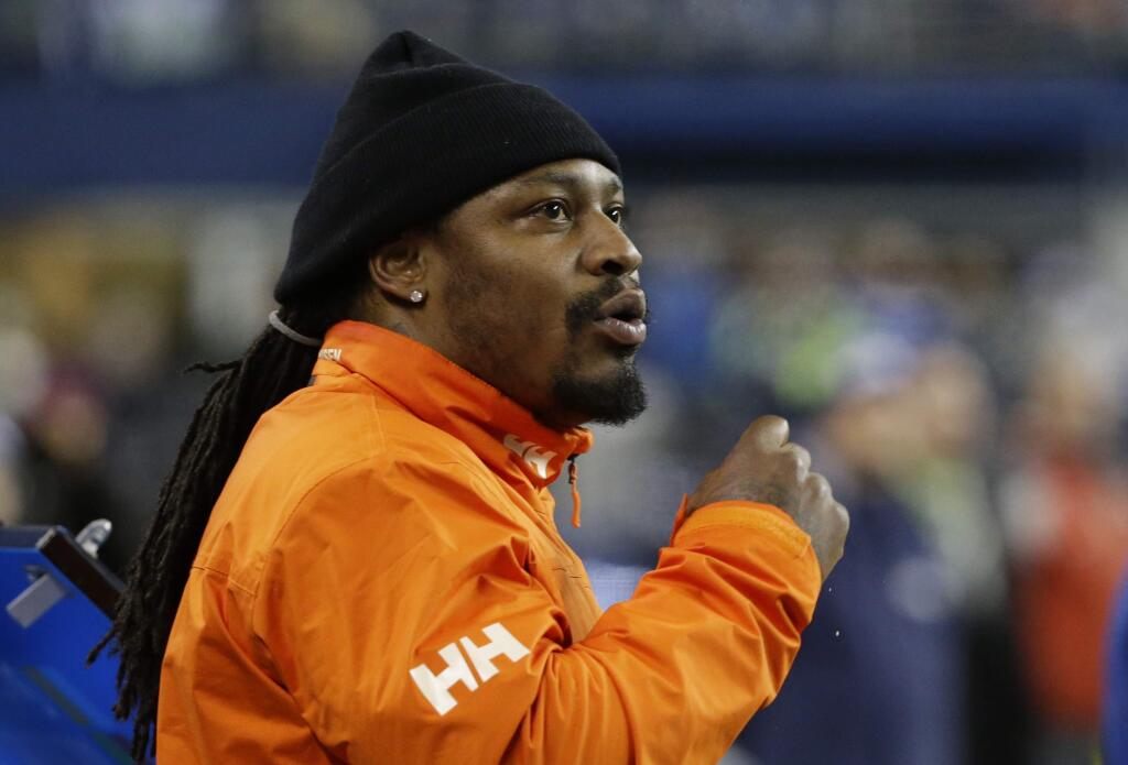 Former Seattle Seahawks running back Marshawn Lynch stands on the sidelines and chats with players on the bench in the second half against the Carolina Panthers, Sunday, Dec. 4, 2016, in Seattle. (AP Photo/Ted S. Warren)