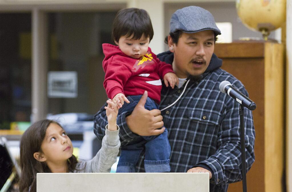 Robbi Pengelly/Index-TribuneKarym Sanchez, with the North Bay Organizing Project, with daughter Keryn, 8, and son Emiliano, 9 months, was among the audience members who addressed the school board.