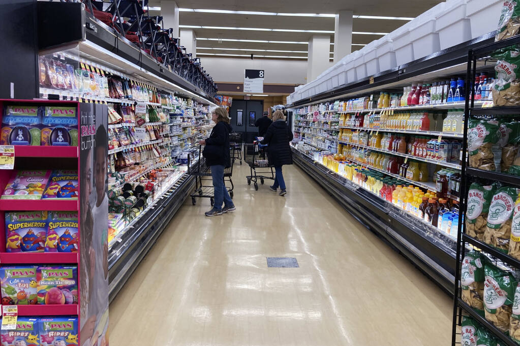 FILE - Customers shop at a grocery store in Mount Prospect, Ill., on April 1, 2022. (AP Photo/Nam Y. Huh, File)