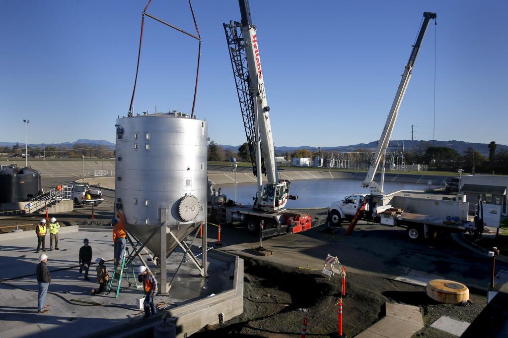 Employees from Pacific Infrastructure Corp. install a high strength waste tank at the Laguna Treatment Plant in Santa Rosa, on Tuesday, December 15, 2015. (BETH SCHLANKER/ The Press Democrat)
