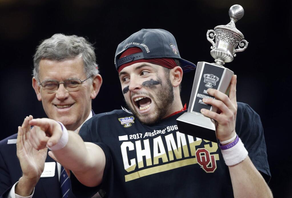 Oklahoma quarterback Baker Mayfield reacts to teammates as he holds the most outstanding player trophy after the Sugar Bowl NCAA college football game against Auburn in New Orleans, Monday, Jan. 2, 2017. Oklahoma won 35-19. (AP Photo/Gerald Herbert)
