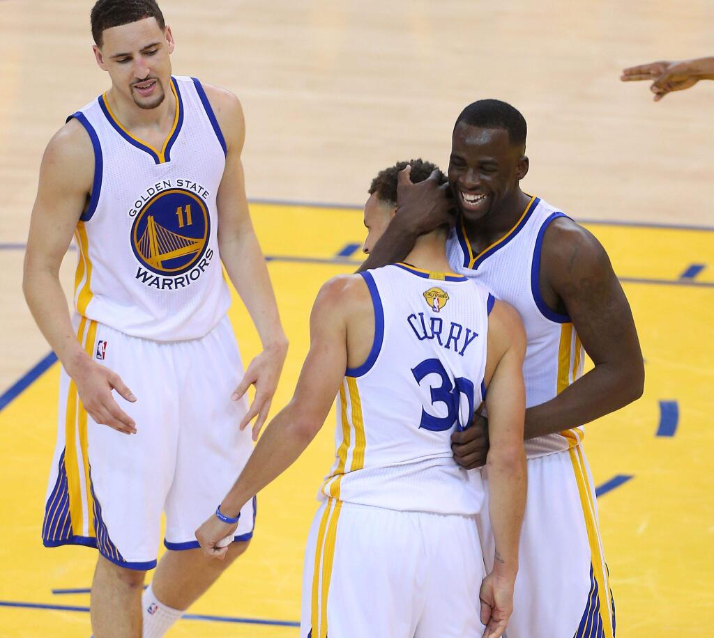 Golden State Warriors teammates (from left) Klay Thompson, Stephen Curry and Draymond Green, were among the five members of the team selected Monday as finalists for the 2016 U.S. Olympics team. Also named were Andre Iguodala and Harrison Barnes. (Christopher Chung/ The Press Democrat)