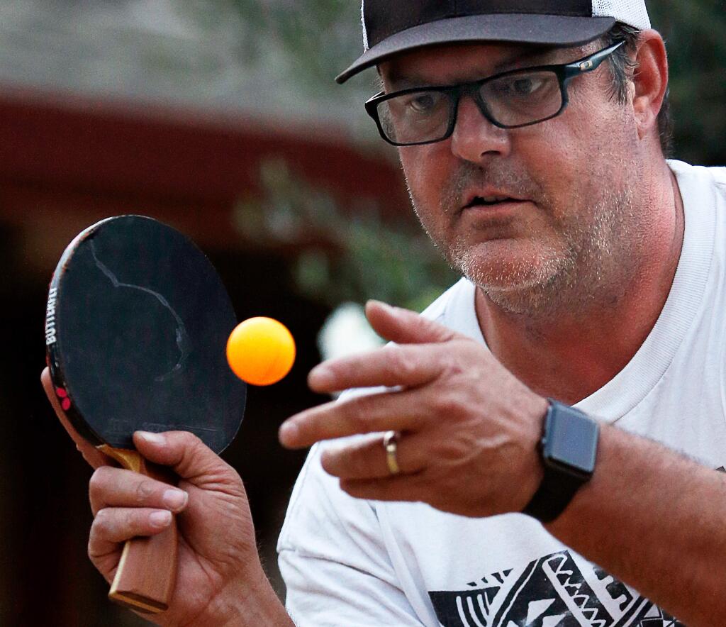 Palooza Gastropub owner Jeff Tyler serves to an opponent during the weekly ping-pong tournament at Palooza Gastropub in Kenwood, California, on Tuesday, September 12, 2017. (Alvin Jornada / The Press Democrat)
