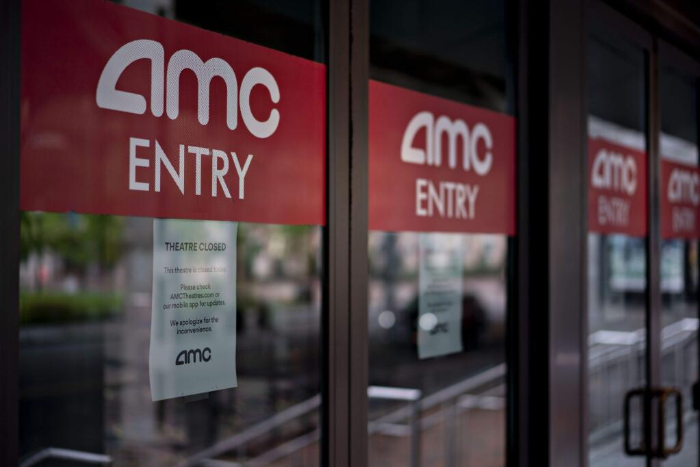 Temporarily closed signs hang on doors at an AMC Entertainment Holdings Inc. movie theater in the Georgetown neighborhood of Washington, D.C., on April 8, 2020. (Bloomberg photo by Andrew Harrer)