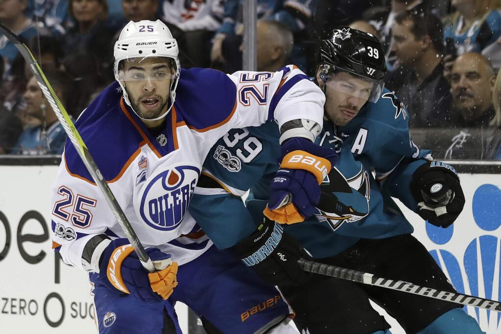 The San Jose Sharks' Logan Couture (39) gets tangled with the Edmonton Oilers' Darnell Nurse (25) during the first period in Game 4 of a first-round playoff series Tuesday, April 18, 2017, in San Jose. (AP Photo/Marcio Jose Sanchez)