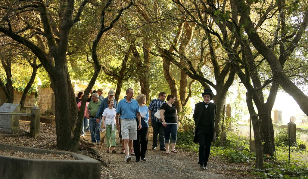 Bill Montgomery, playing the roll of Herbert Moke, funeral director and undertaker, leads a tour through the Santa Rosa Rural Cemetery. (CRISTA JEREMIASON / The Press Democrat, 2014)