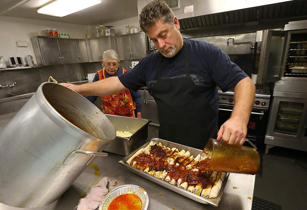 Mary Cook, left, and Dan Cahill have been cooking for St. Vincent de Paul kitchen in Santa Rosa for the past 10 years. (JOHN BURGESS / The Press Democrat)