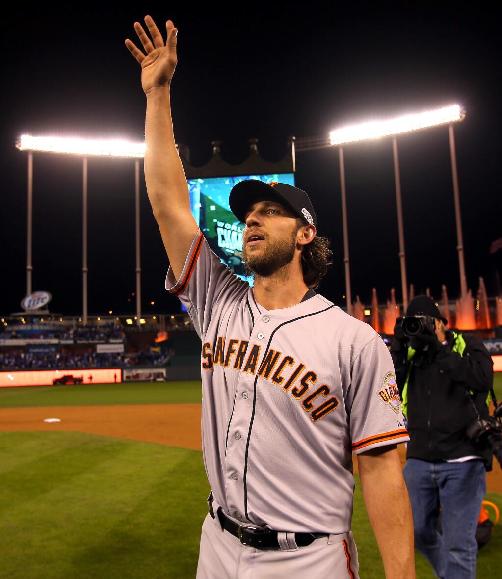 San Francisco Giants pitcher Madison Bumgarner waves to Giants fans after beating the Kansas City Royals in Game 7 of the World Series in Kansas City on Wednesday, Oct. 29, 2014. (Christopher Chung / The Press Democrat)