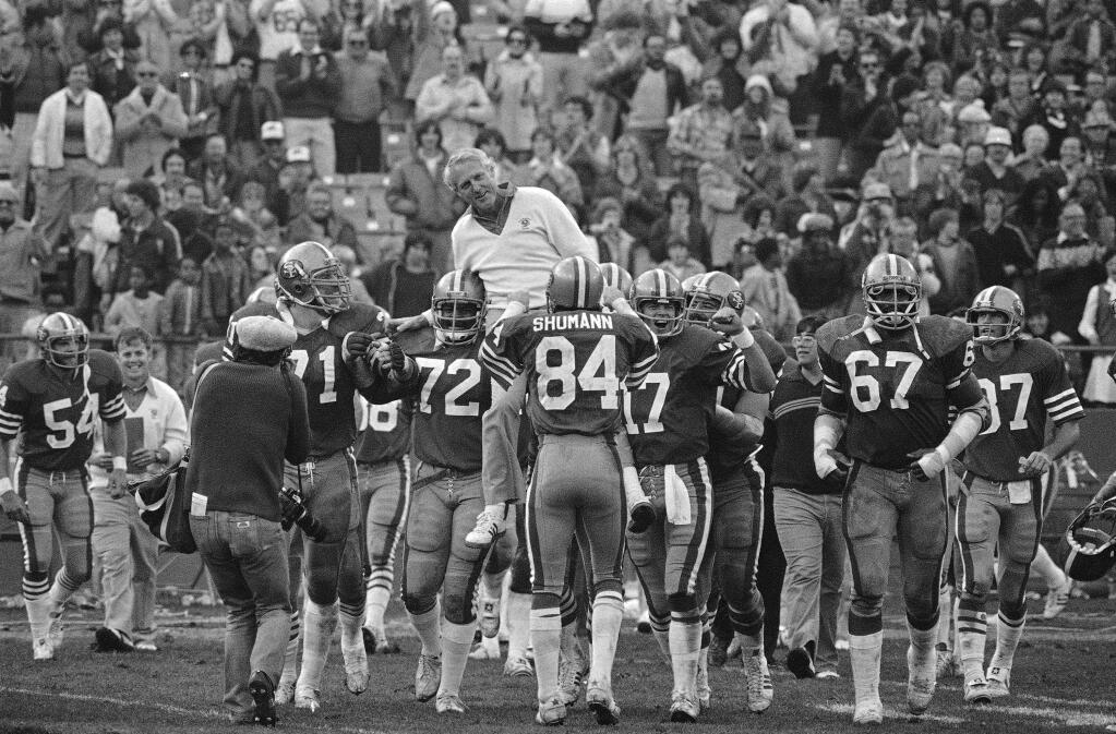 Jubilant 49ers, among them quarterback Steve DeBerg (17), at right, hoist coach Bill Walsh to their shoulders for a victory ride after beating the Tampa Bay Buccaneers, 23-7, at San Francisco on Dec. 9, 1979. (AP Photo/Paul Sakuma)